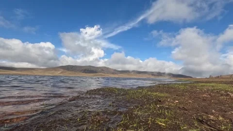 Timelapse of lagoon with mountains and clouds in the background. Stock Footage 229582687