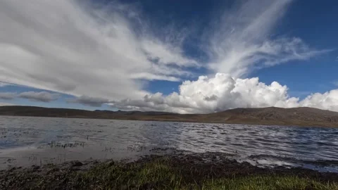 Timelapse of lagoon with mountains and clouds in the background. Stock Footage 229582716