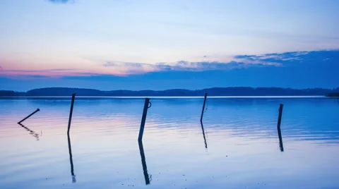 Timelapse of lake after sunset with sky reflected in water (4k) Stock Footage 61160723