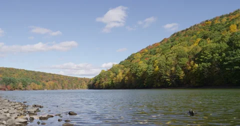 A timelapse of a lake and fall trees on mountains Stock-Footage 144979393