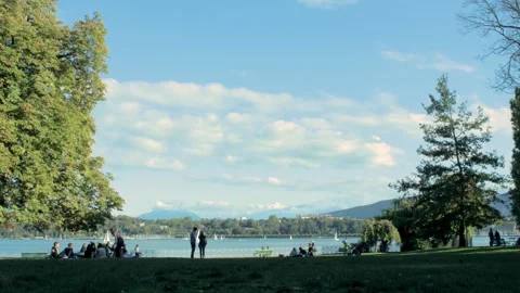 Timelapse from Lake Geneva from a park with clouds and mountains Stock Footage 261281706