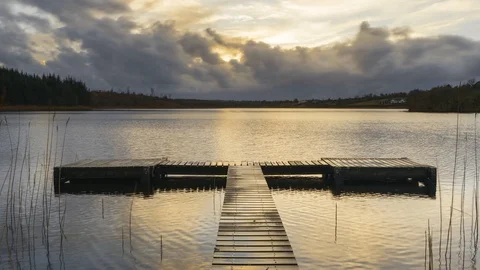 Timelapse of Lake Jetty during dramatic cloudy sunset evening Stock Footage 100968397