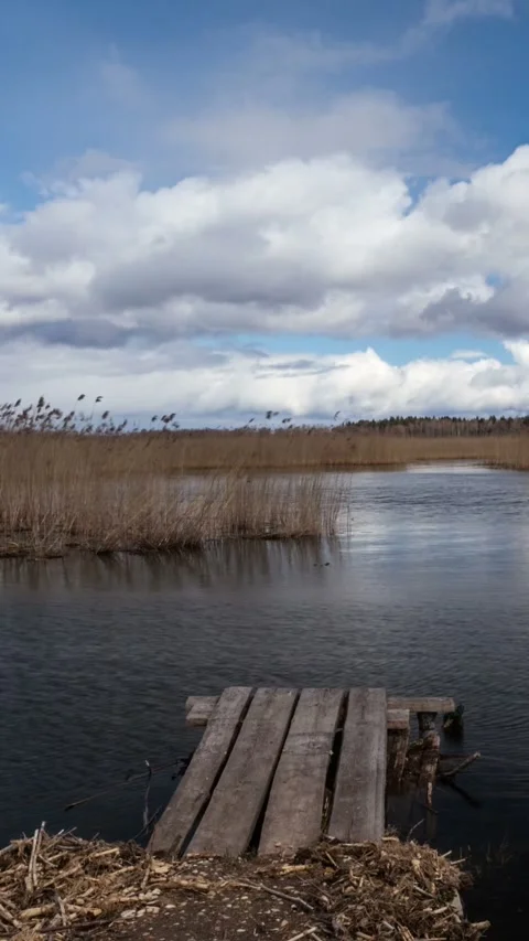 Timelapse of lake with pier and clouds Stock Footage 236701347