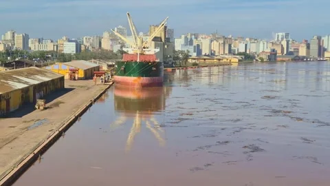 Timelapse of a large bulk carrier vessel unloading at a dirty river port Stock Footage 346330365