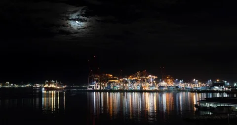 A timelapse of a large cargo terminal with heavy lift cranes loading shipping Stock Footage 118173750