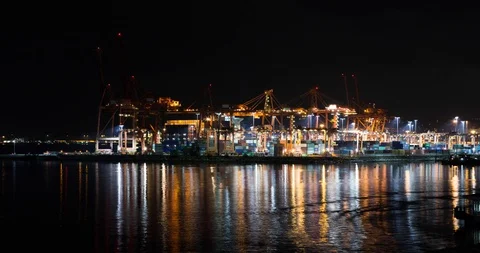 A timelapse of a large cargo terminal with heavy lift cranes loading shipping Stock Footage 118173914