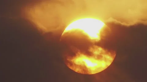 Timelapse, a large sun sets in orange clouds that turn blue. Stock Footage 155845383