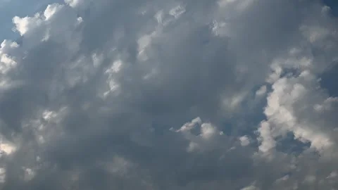 Timelapse of late day gray to white clouds moving diagonally across the frame Stock Footage 340990776