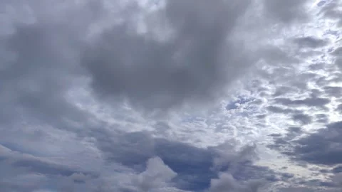 Timelapse of layered high white and low gray clouds in sky. summer cloudscape. Stock Footage 302172444