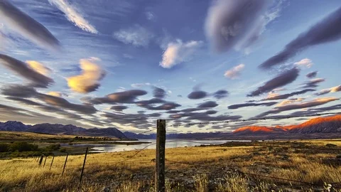 Timelapse of Lenticular clouds and rustic landscape at sunset Stock Footage 73844099