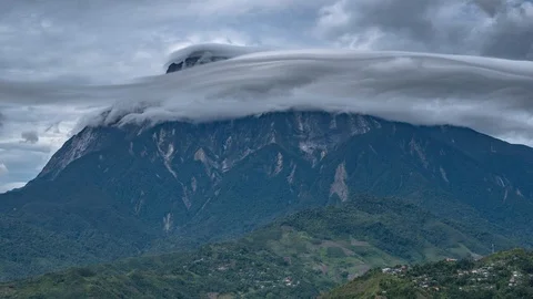Timelapse of lenticular clouds hovering a mountain. Mount Kinabalu, Sabah, Stock Footage 96618165