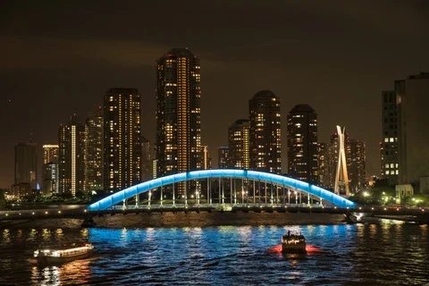 Timelapse of light up bridge above river at night, buildings in back, Tokyo Stock Footage 136158068