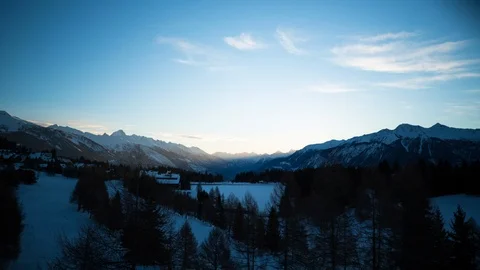 Timelapse of light clouds travelling across sky above edge of Engelberg city Stock Footage 129099820