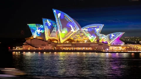 TImelapse of light display on the Opera House sails viewed from Circular Quay Stock Footage 200046581