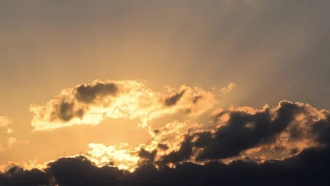 Timelapse of light rays and sunshafts coming through clouds on a sunset sky Stock Footage 78456229