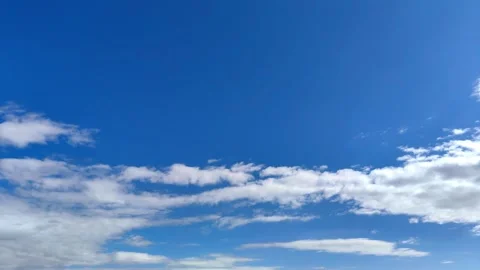 Timelapse light white clouds moving rapidly across blue sky daylight. copy space Stock Footage 301997168