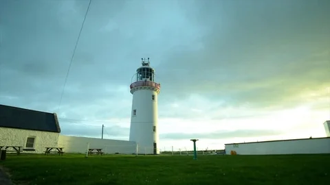 Timelapse Lighthouse with fast moving clouds at sunrise in Loop Head, Ireland. Stock Footage 81197496