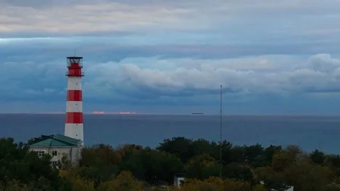 Timelapse lighthouse on the sea under stormy clouds and with the ship in the Stock-Footage 69216671