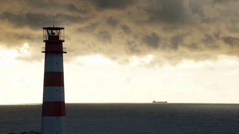 Timelapse lighthouse on the sea under stormy clouds and with the ship in the Stock-Footage 70525503