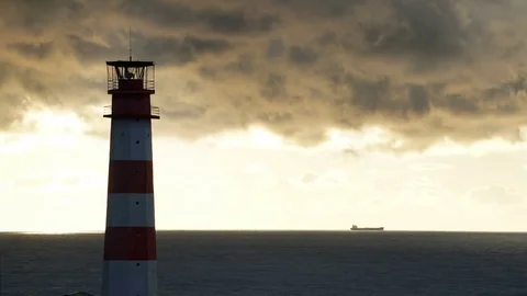 Timelapse lighthouse on the sea under stormy clouds and with the ship in the Видео 70526356
