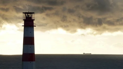 Timelapse lighthouse on the sea under stormy clouds and with the ship in the Видео 70658116