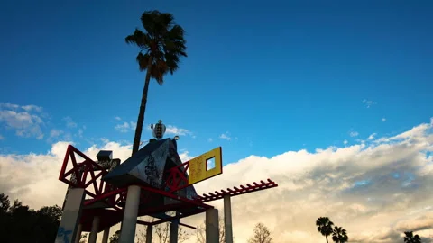 Timelapse Lockdown Of A Park Sculpture With Graffiti And A Tall Palm Tree At Stock Footage 234081852