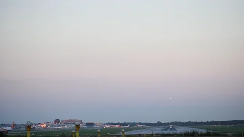 Timelapse looking down the runway at Gatwick Airport taken over sunset Stock Footage 102519897