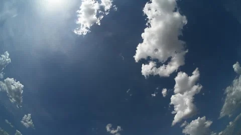 Timelapse looking straight up into a blue sky with cumulus clouds floating Stock Footage 340240201