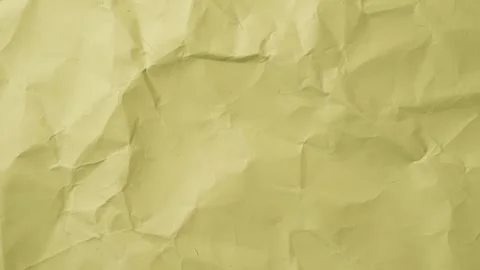 Timelapse loop of yellow crumpled paper sheet. Wrinkled, torn, and textured Stock Footage 309965180