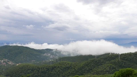 Timelapse low flying curling white clouds over mountains, Barcelona Stock Footage 99921535