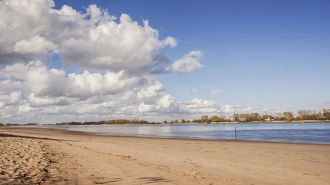 Timelapse of low lying clouds moving over river with beach Stock Footage 127287536