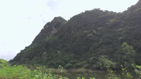 Timelapse of majestic cliffs, located next to a blue lake, clouds and sky Stock Footage 260321451