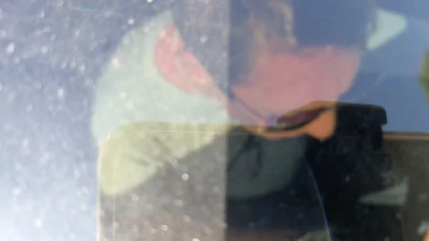 Timelapse of man driving car looking down through car sunroof window Stock Footage 231175756
