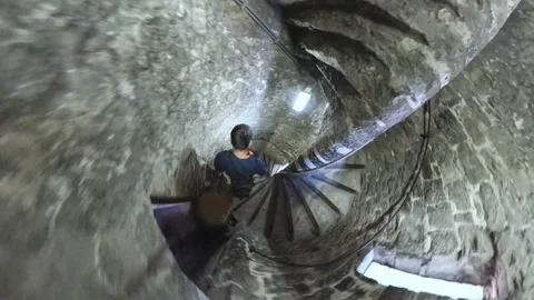 Timelapse of a man exploring the interior of a medieval tower. Fisheye POV. Video stock 121197529