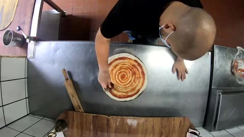 Timelapse of a Man with a Facemask Making a Pizza inside a Restaurant Kitchen. Stock Footage 213609465