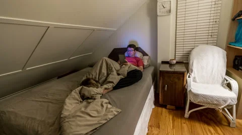 Timelapse of man reading on tablet and the sleeping, with cat on the bed Stock Footage 51781748