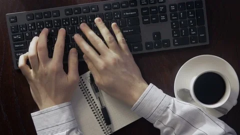 Timelapse of man taking notes and drinking coffee in the office Stock Footage 75945366
