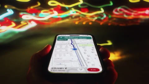 Timelapse of man walking through city at night using smartphone navigation app Stock Footage 331268634