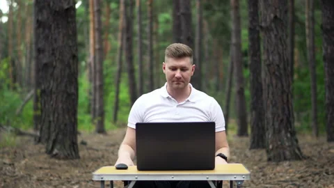 Timelapse of Man working in the Forest with Laptop and Smart Phone Stock Footage 138631743