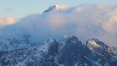 Timelapse of Mangart Mountain in the winter with clouds passin Stock Footage 231795859