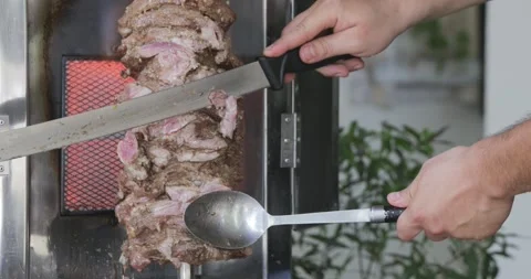 Timelapse of man's hand cutting skewered meat- traditional shawarma or kebab on Stock-Footage 151478629