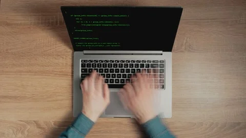 Timelapse of man's hands are typing commands of a laptop keyboard. A man is Stock Footage 149775717