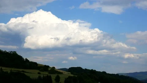 Timelapse - Massive clouds in the distance over the hilly landscape Stock Footage 135910004
