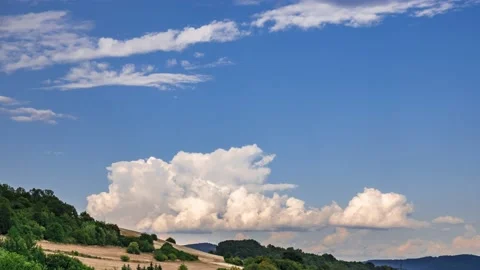 Timelapse - Massive clouds in the distance rising high into the sky Stock Footage 134912011