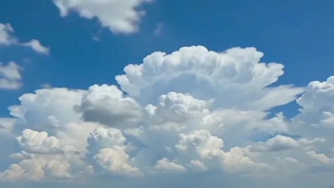 Timelapse of Massive Fluffy Cumulonimbus Cloud Formation in Blue Sky Stock Footage 344900333