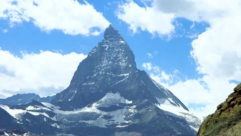 Timelapse of Matterhorn Mountain with clouds in blue sky Stock Footage 323167308