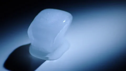 Timelapse of melting ice cube with dramatic lighting Stock Footage 250082051