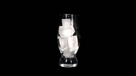 Timelapse of melting ice cubes in a glass against black background. Stock Footage 10838457