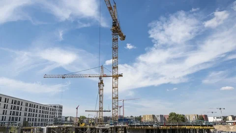Timelapse of men at work and operating cranes at construction site. Stock Footage