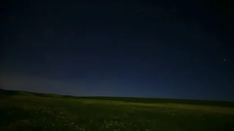Timelapse of a Meteor Shower Streaking Across the Starry Night Sky Over Rural 動画素材 337442274